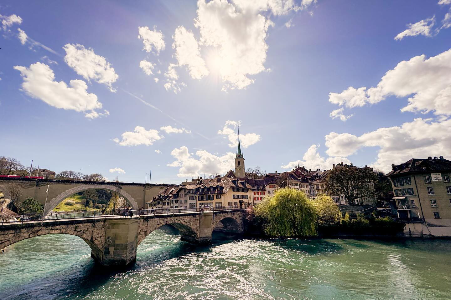 A wide-angle view of a sunny day at the Untertor bridge in the old town of Bern